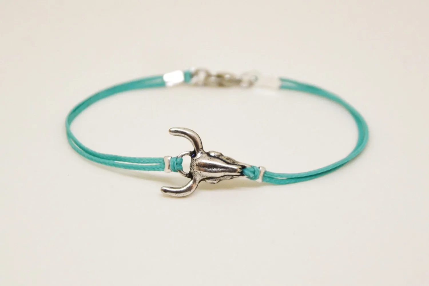 Men's bracelet with silver bull charm, turquoise cord, bull skull