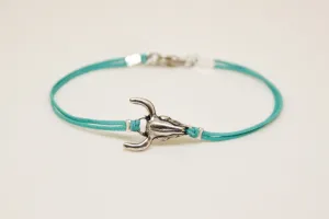 Men's bracelet with silver bull charm, turquoise cord, bull skull